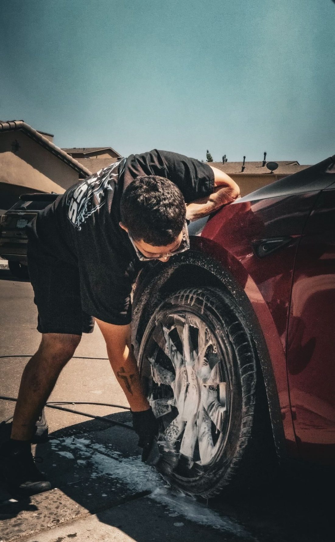 Detailing a wheel on a red car